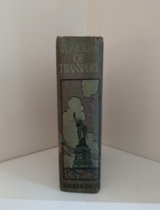 binding with the image of statue of Liberty, on an Antique Book Wonders of Transport, By Cryril Hall, Triumphs of Enterprise