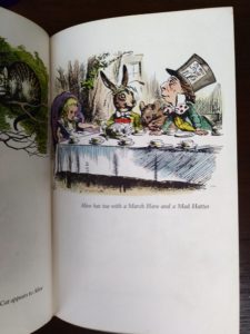 page 39, volume 12 of The Best in Childrens Books, illustration of Alice having tea with a March Hare and a Mad Hatter