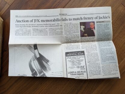 Ephemera inside 1964 REPORT OF THE WARREN COMMISSION - The Assassination of President Kennedy ; Newspaper article from The Vancouver Sun; 'Auction of JFK memorabilia fails to match frenzy of Jackie's'