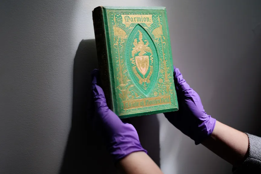 Melissa Tedone tests the covers of antique books for toxic heavy heavy metals