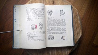 a previous owner drew inside the book with crayon - 1957 The World of Pooh by A. A. Milne