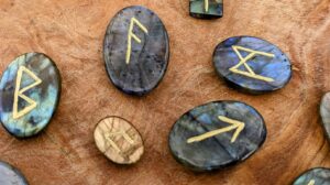 Close up photograph - Rune Set hand carved on 520 Ct Polished Rainbow Labradorite - Ash Tree Runes
