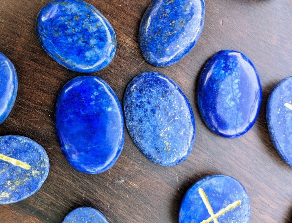Hand carved Elder Futhark Rune set on 1115 Carats of Lapis Lazuli with golden Pyrite - reverse side of stones up close