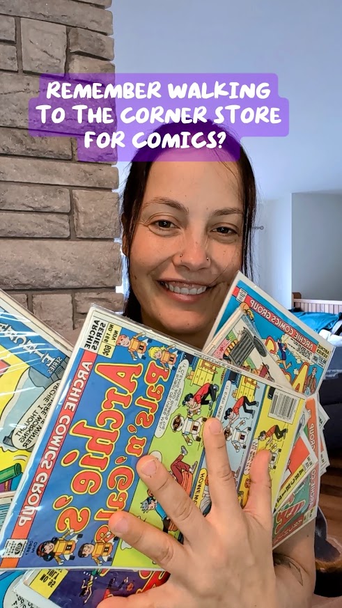 Ashley holding up a Lot of Vintage Archie Comics - Copper & Bronze Age
